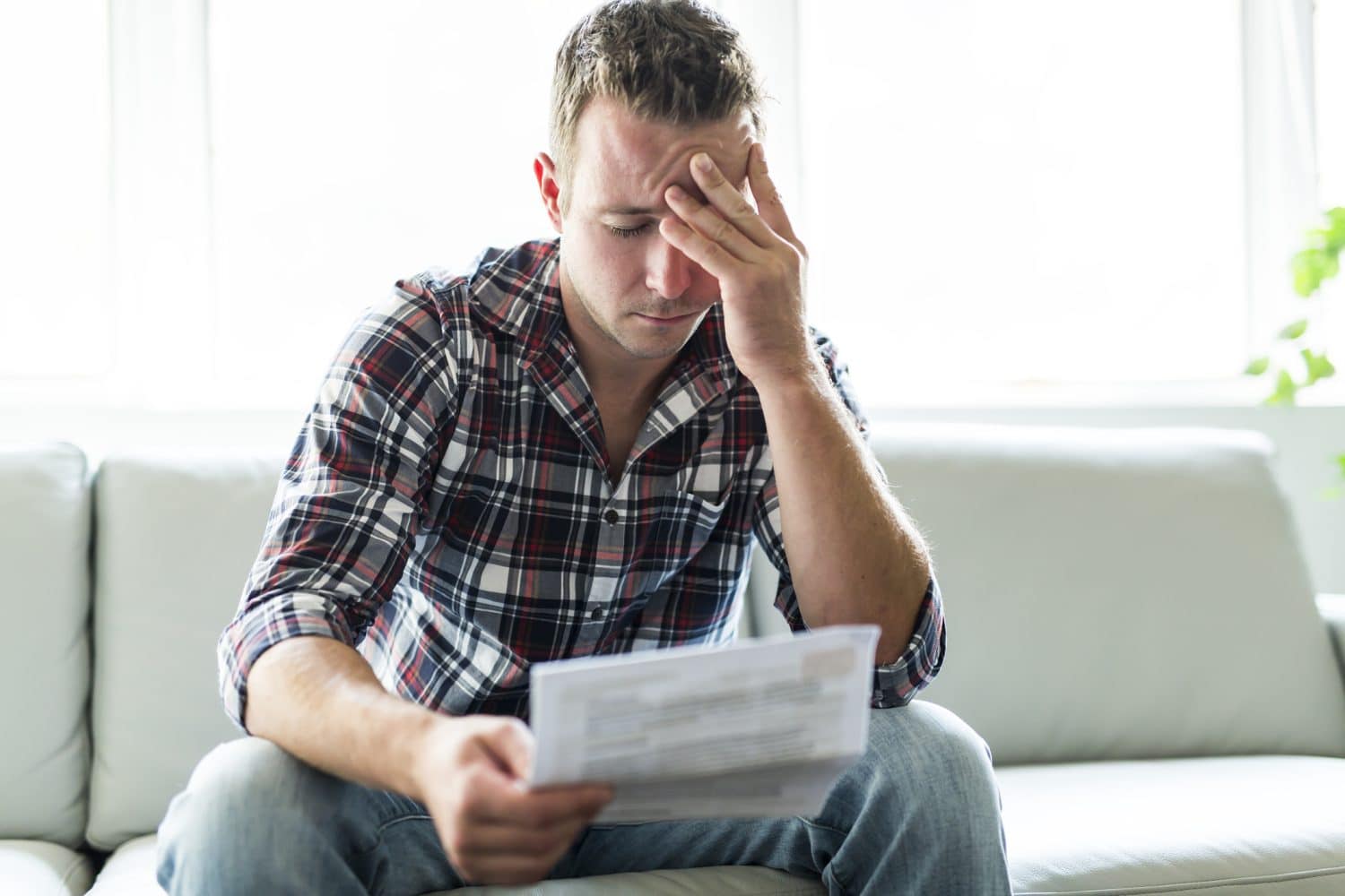 A man reading paperwork about his claim after a personal injury.