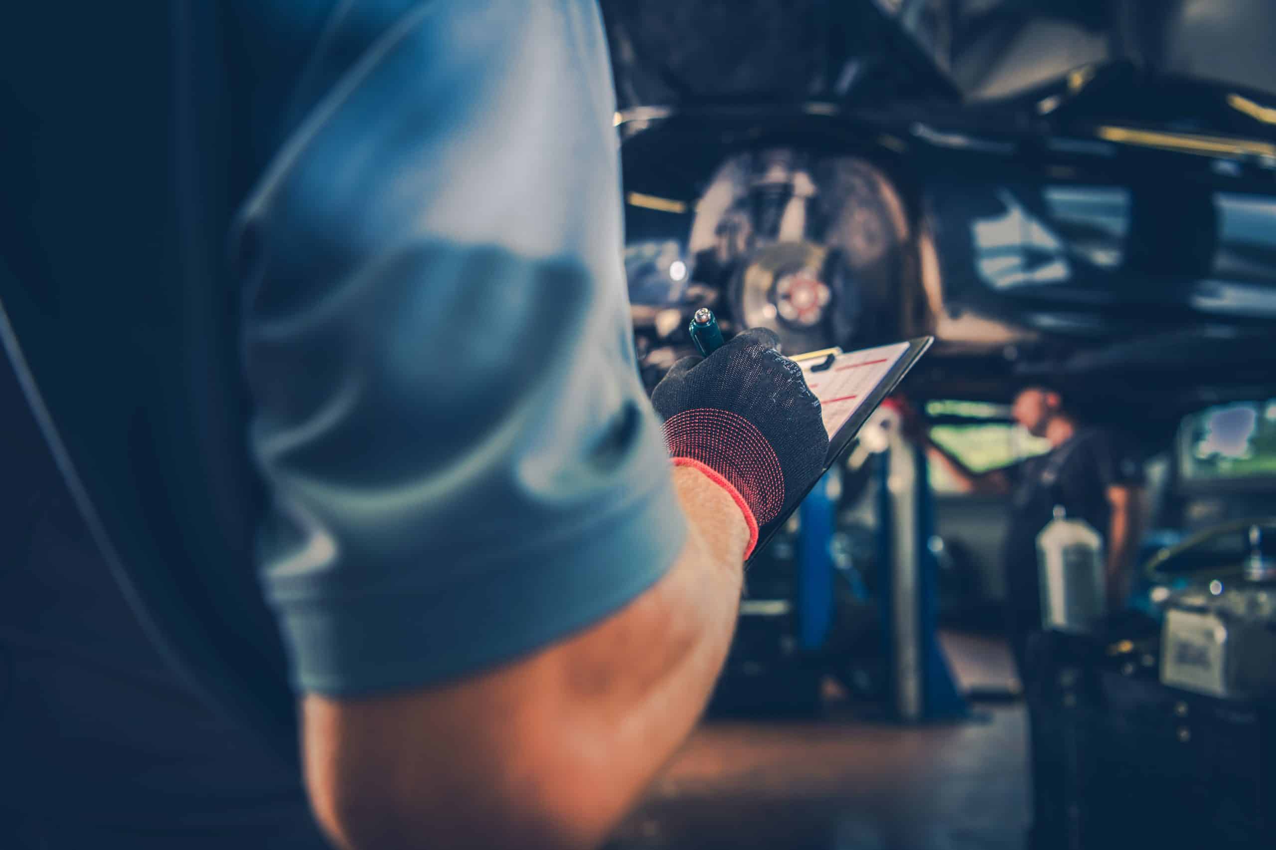 mechanic-going-through-car-maintenance-checklist