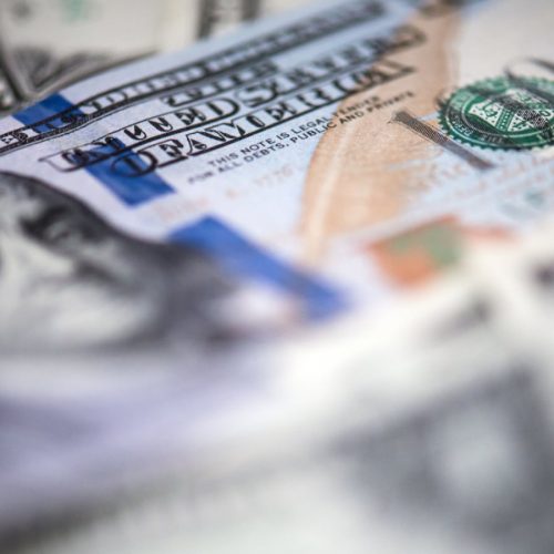 Close-up of a pile of U.S. $100 bills.