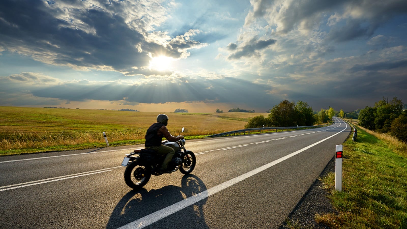 Man Riding Motorcycle In Rural Area Stock Photo