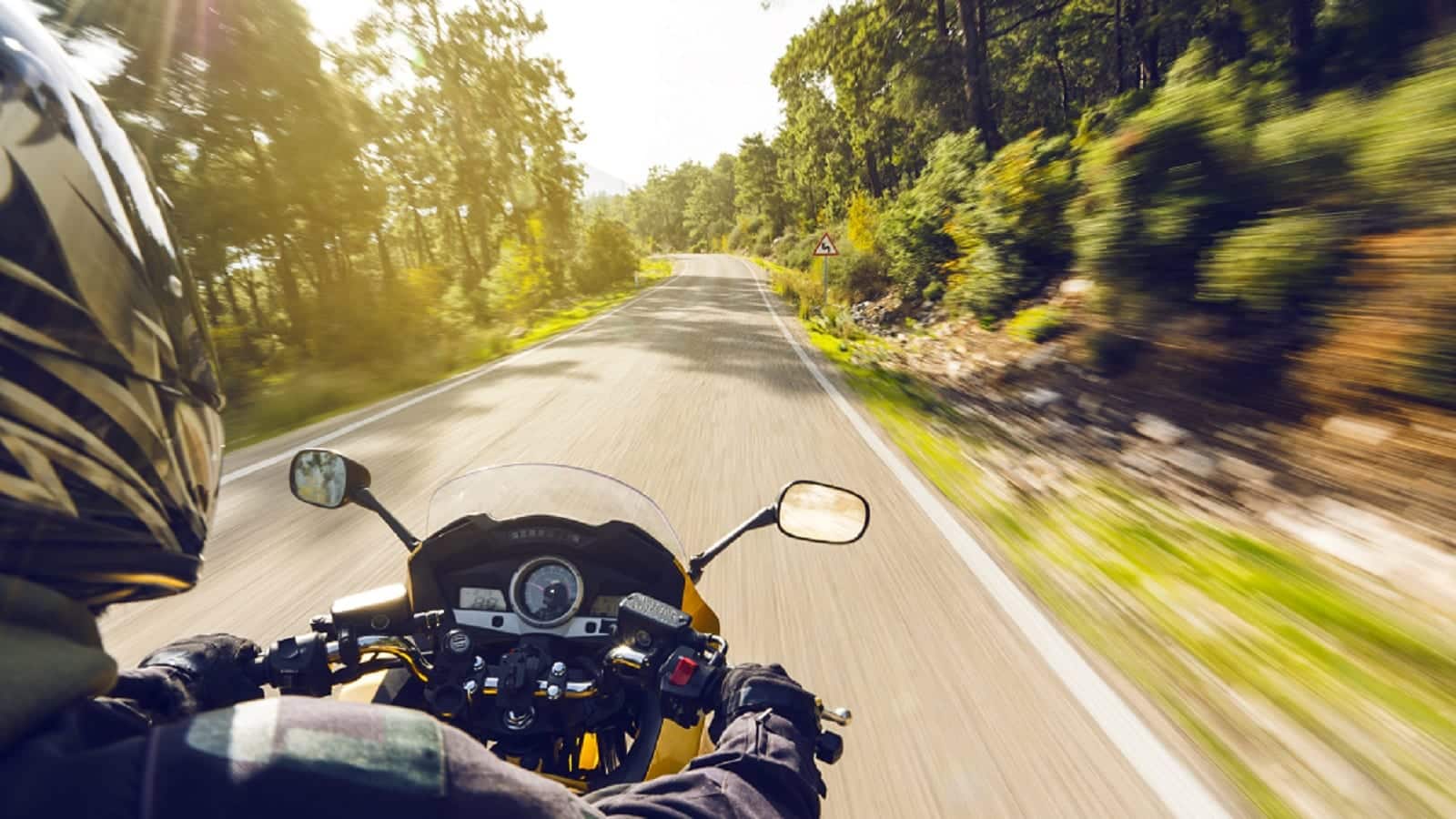 Motorcyclist Riding On A Rural Road Stock Photo