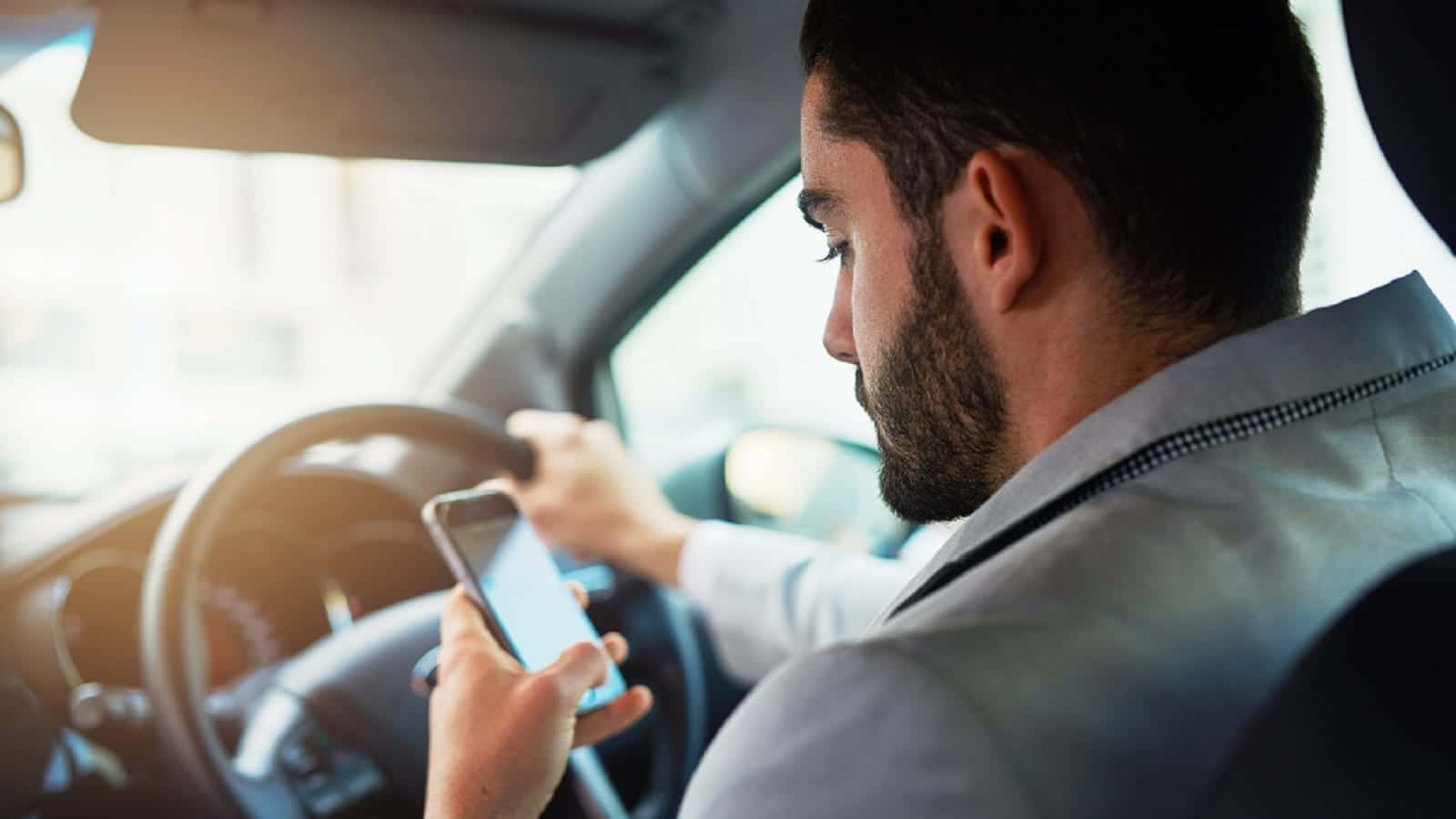 Millenial Texting While Driving Stock Photo