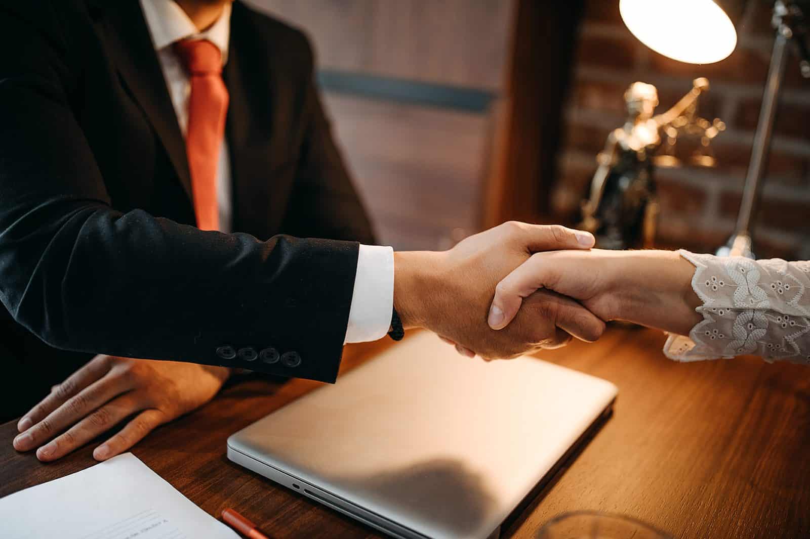 Attorney shaking hands with client